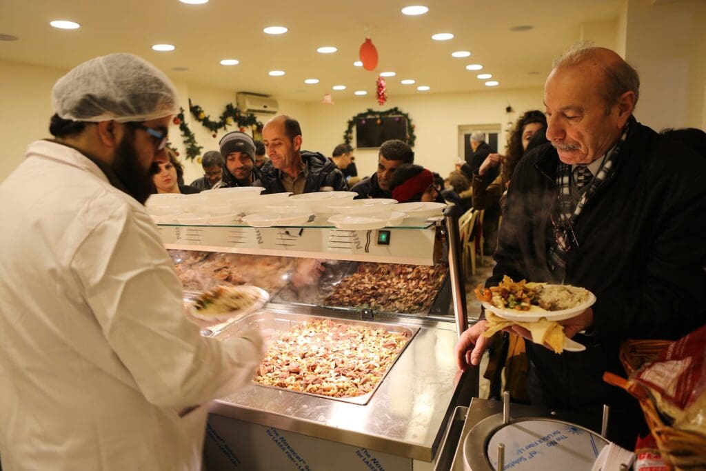 man being served a plate at a food pantry.
