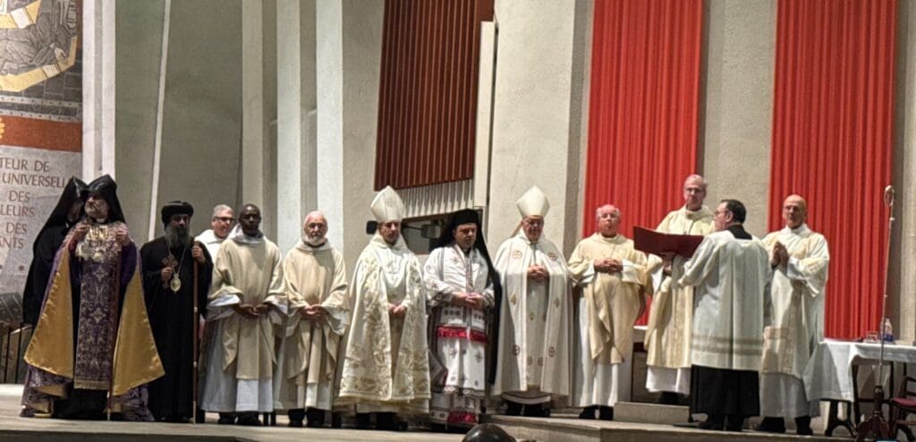 Many bishops and priests participate in Mass in a cathedral.
