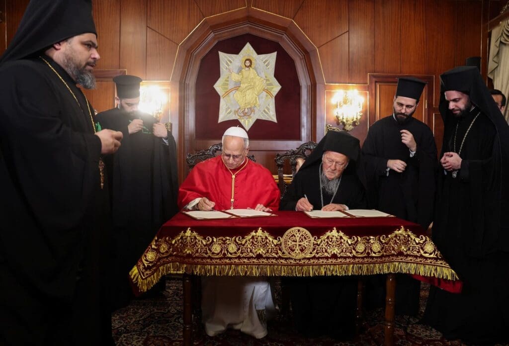 Pope Leo XIV and Ecumenical Patriarch Bartholomew I sign a joint declaration.