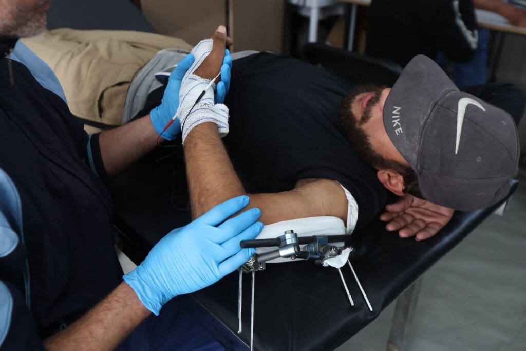 A Palestinian war-wounded patient receives medical treatment.