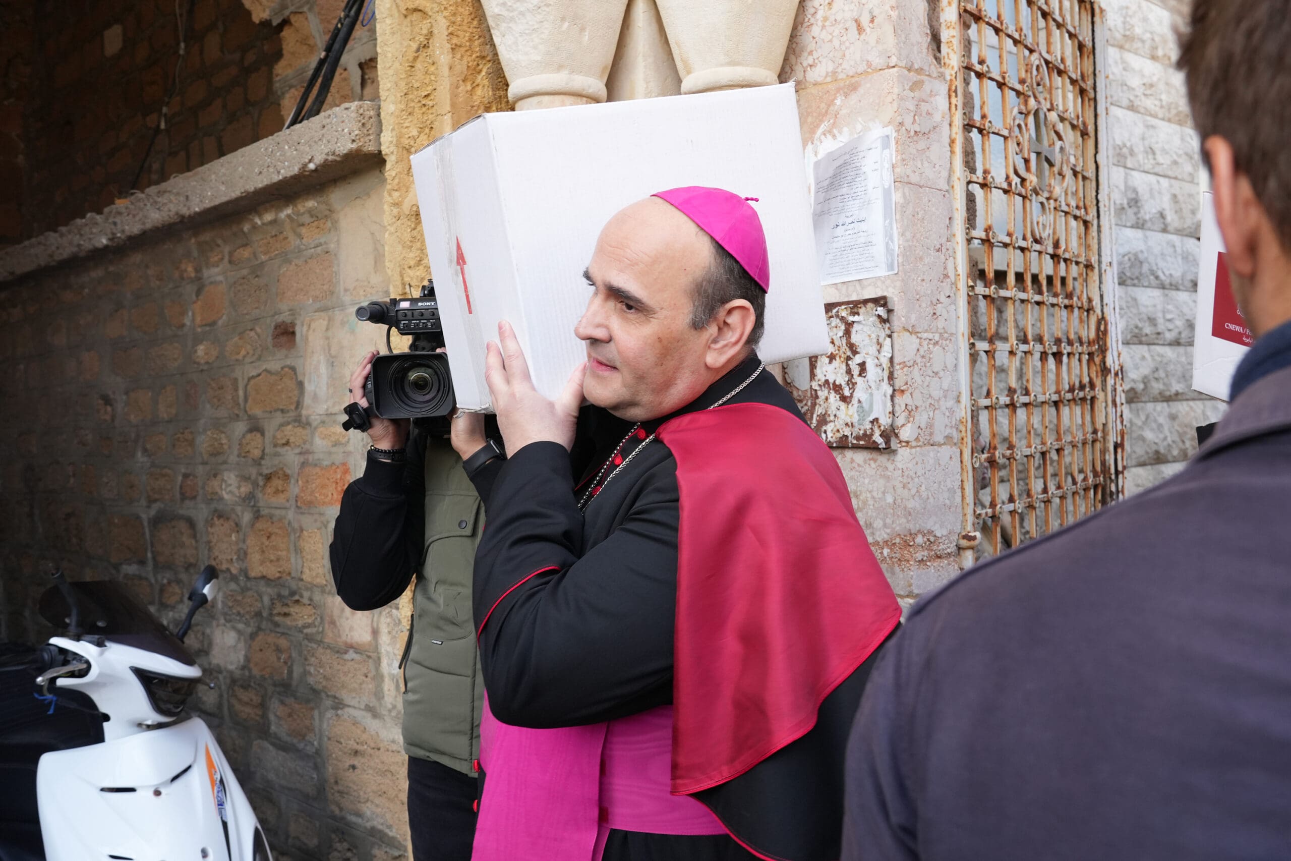 Archbishop Paolo Borgia, apostolic nuncio to Lebanon, carrying a white box on his shoulder.