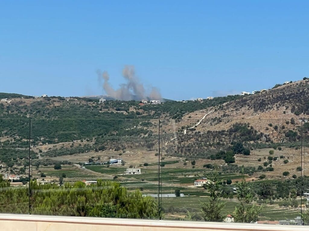Explosions from the ongoing war in southern Lebanon are seen over the Christian town of Debel, Lebanon.