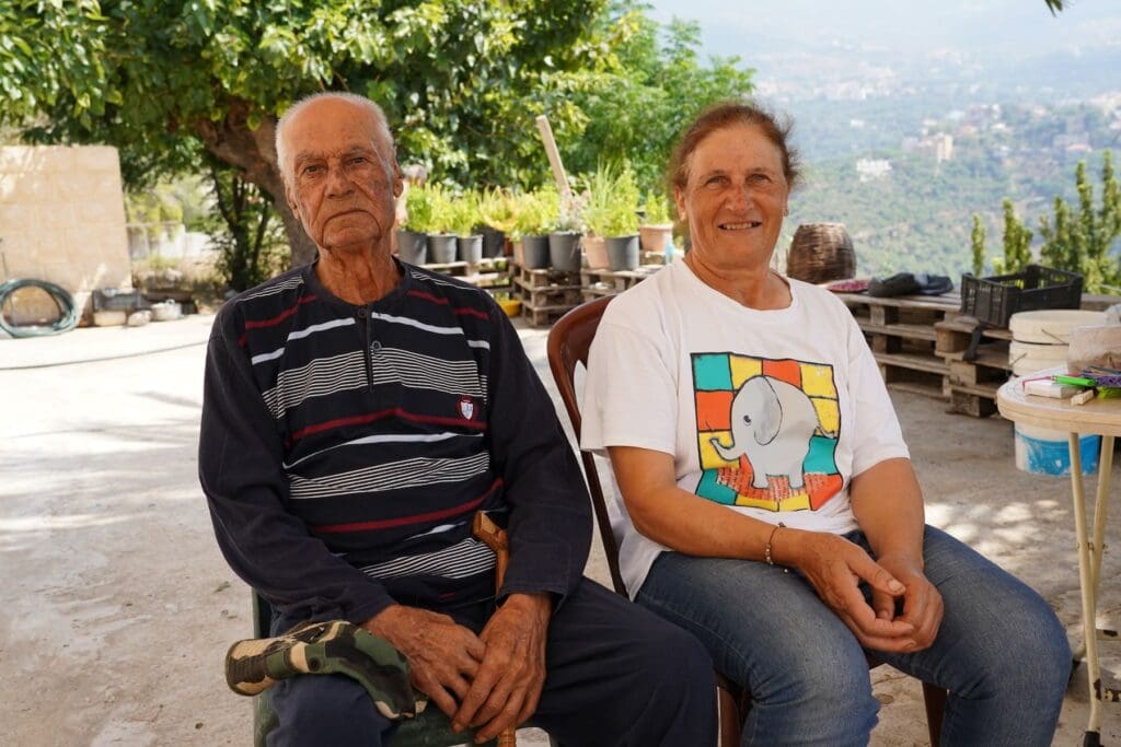 A man and a woman sitting on two chairs next to each other.
