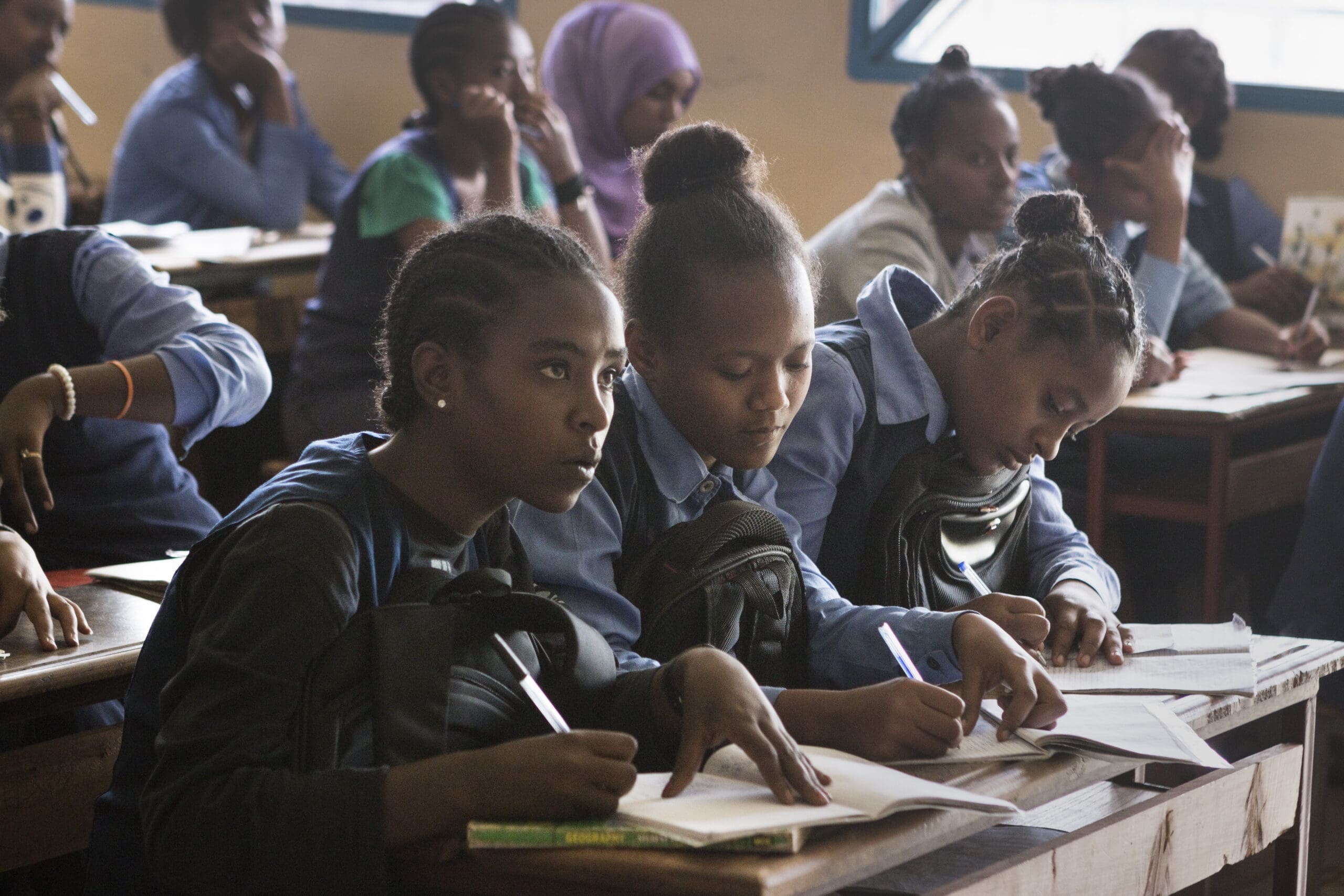 Girls take notes during class in Ethiopia