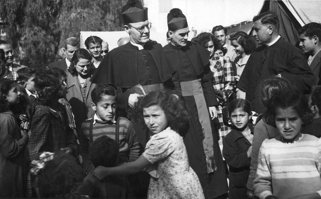 Niños refugiados en Gaza rodean a sacerdotes en 1951.