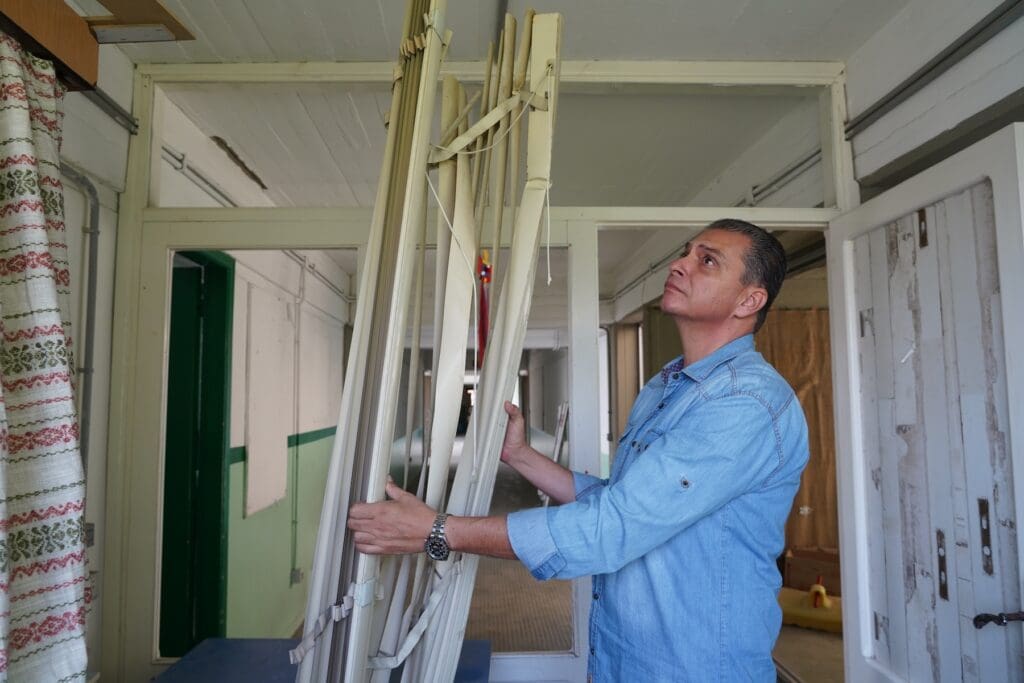 Un hombre limpia escombros en una habitación.
