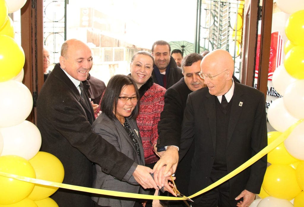 People crowd around for the ribbon cutting at the Pontifical Mission Education and Cultural Center at Bethlehem University.