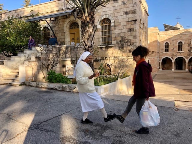 Nun greets volunteer