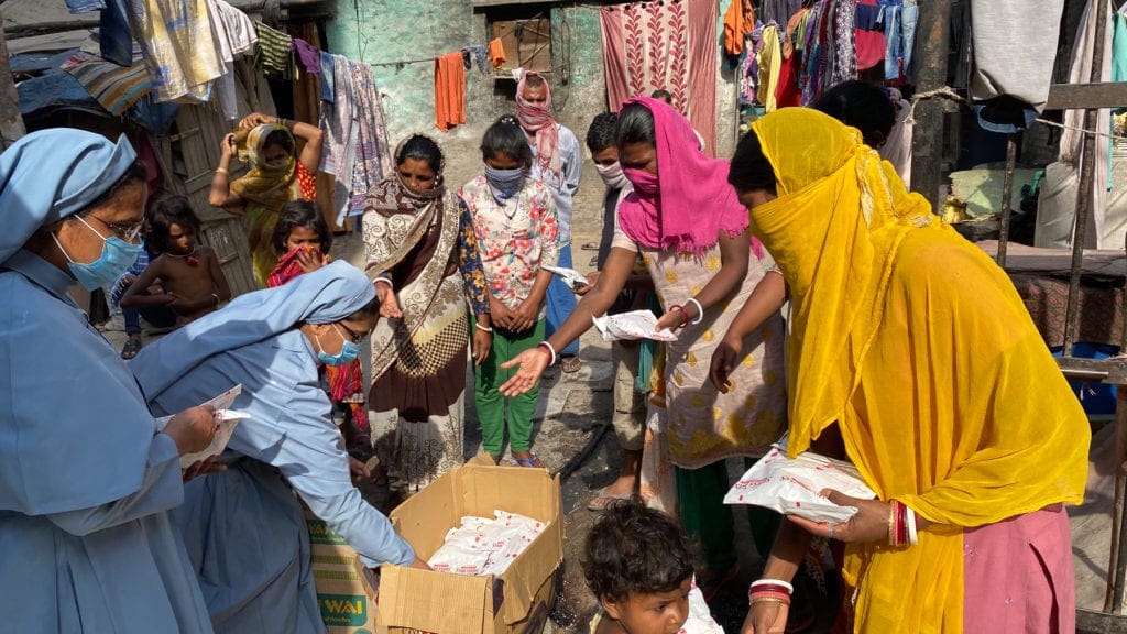 two nuns in india distribute supplies provided by CNEWA.