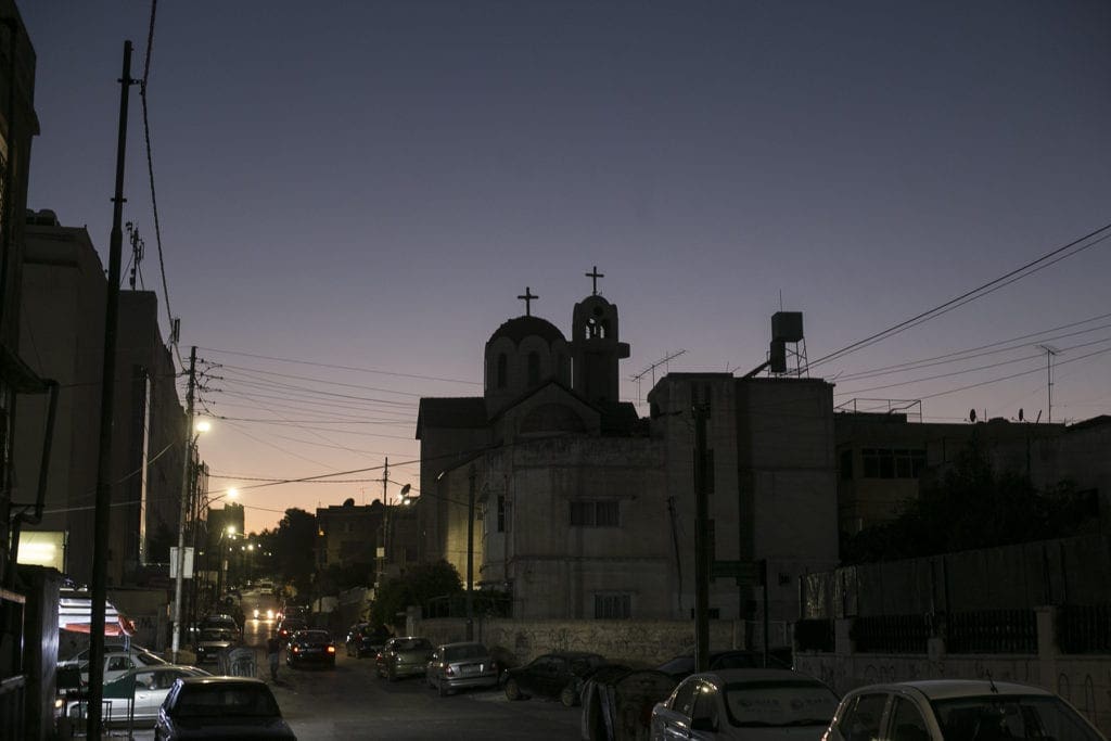 a street of the al hashemi al shamali district of amman is seen in the fading evening light.