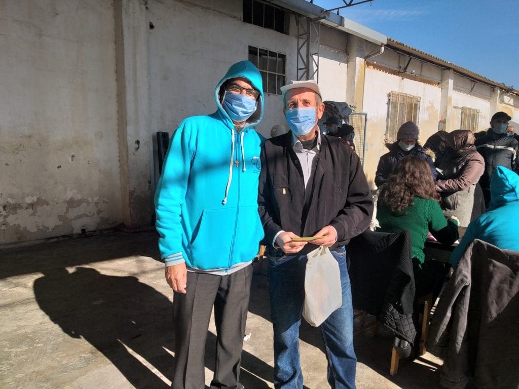 man receives food coupons at Marist Brothers' Center in Aleppo