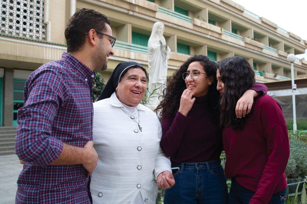 a nun chats with her family outdoors.