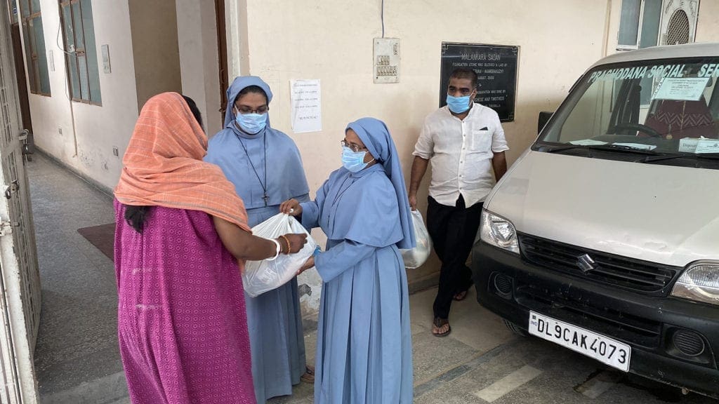 nuns in India distribute goods.