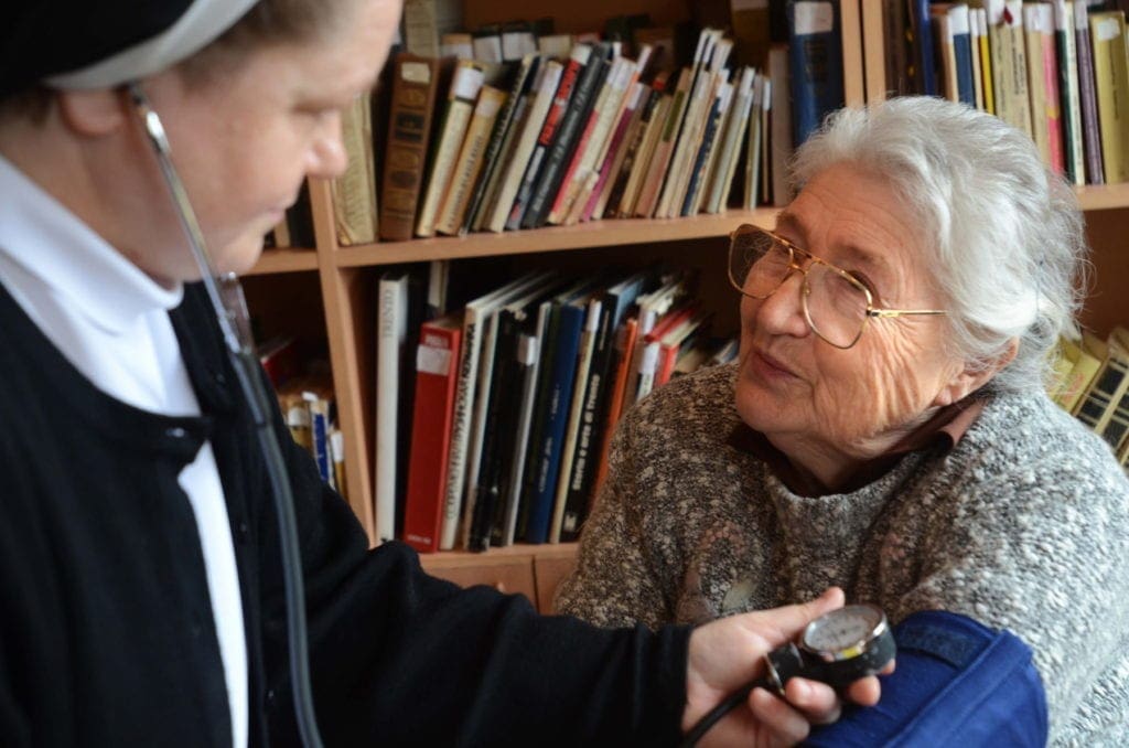 a nun gives a woman a checkup in Georgia.