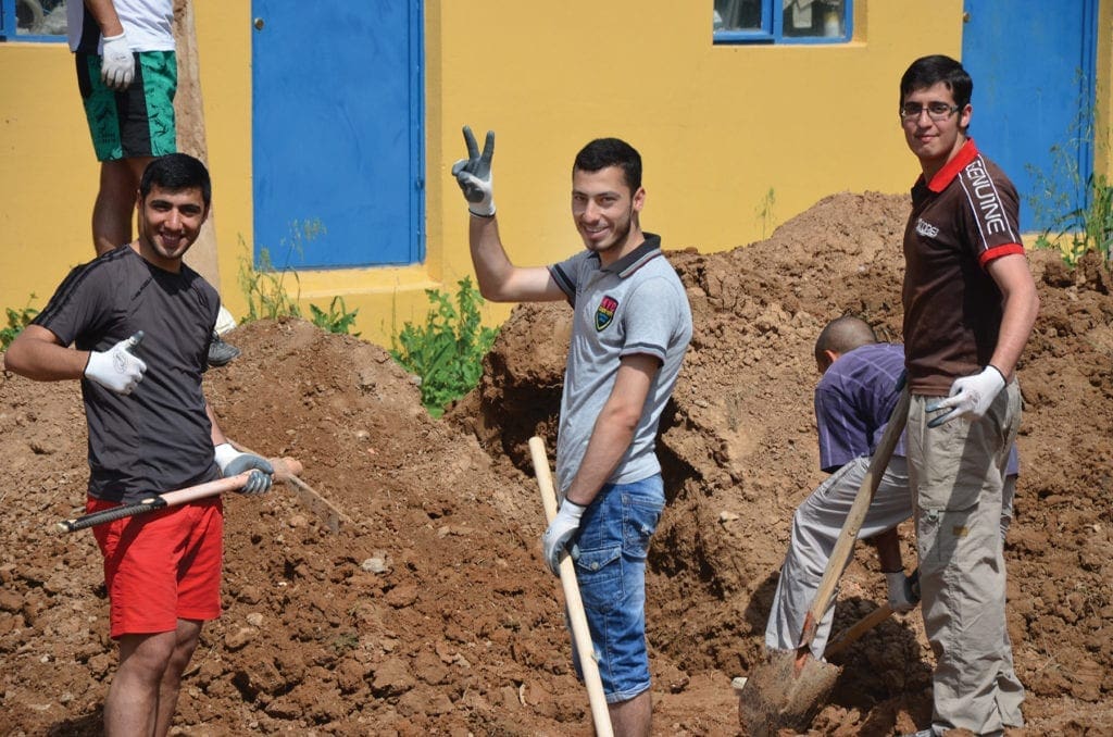 seminarians perform landscaping work.