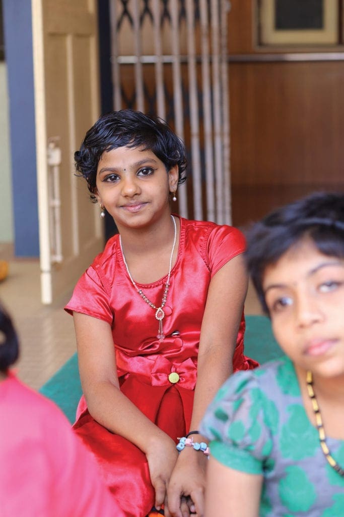 residents of the Home of Faith sit together.