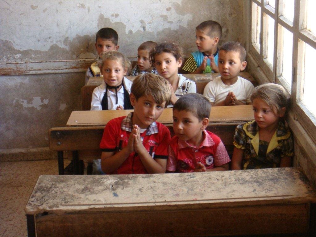 children attend a class in Syria.