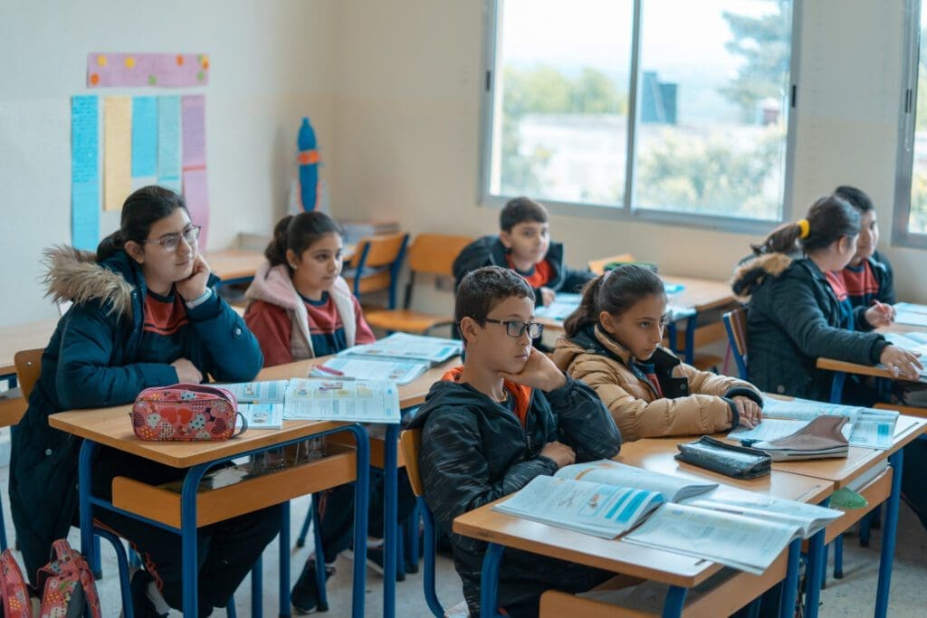 Students sit in a classroom at Holy Family School in Alma El Shaab, Lebanon.