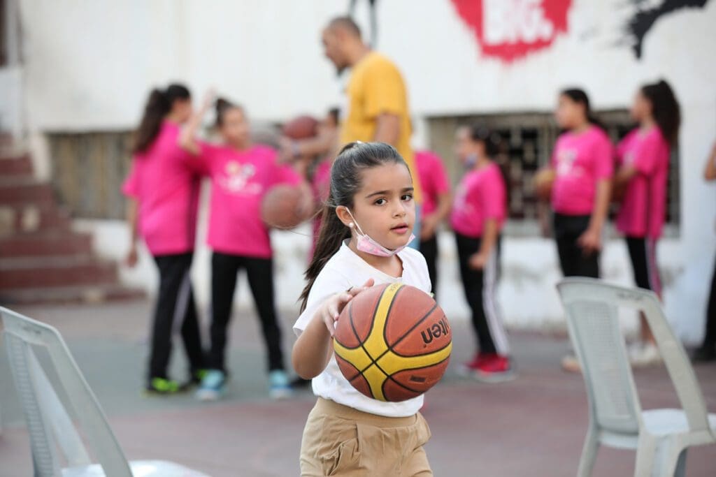 a girl dribbles a basketball.