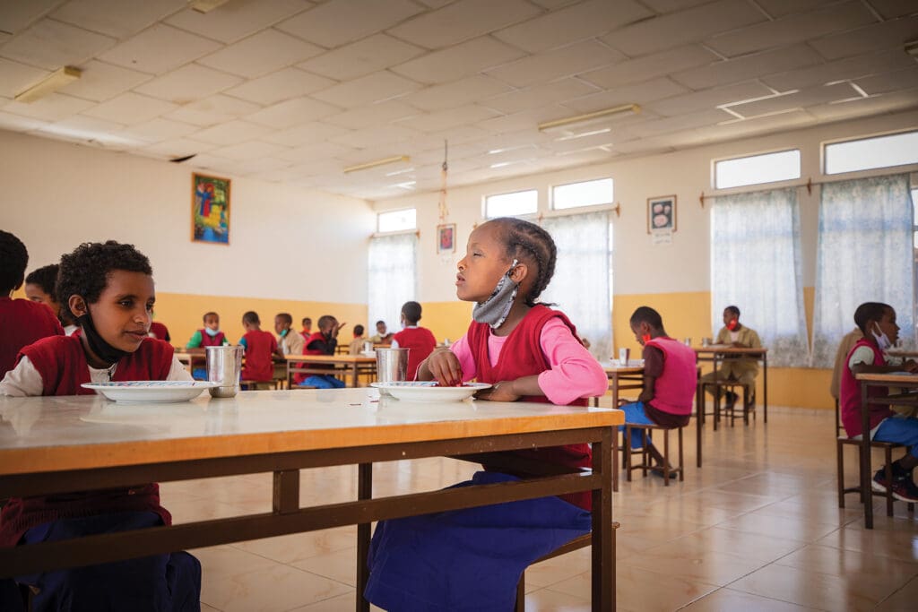 A lunchroom with students.