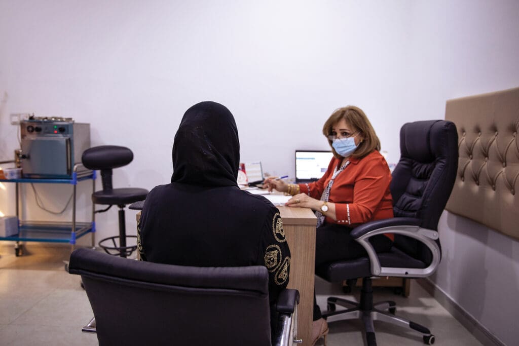 A doctor confers with a patient.