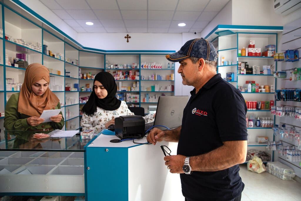 A man stands at a store counter.