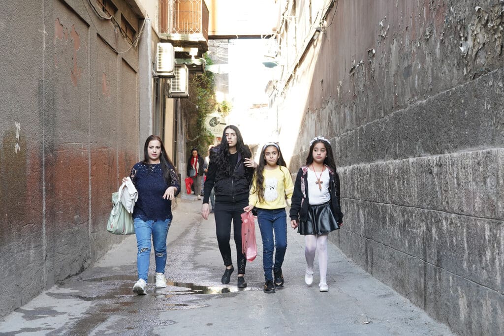 Girls walk towards the camera.