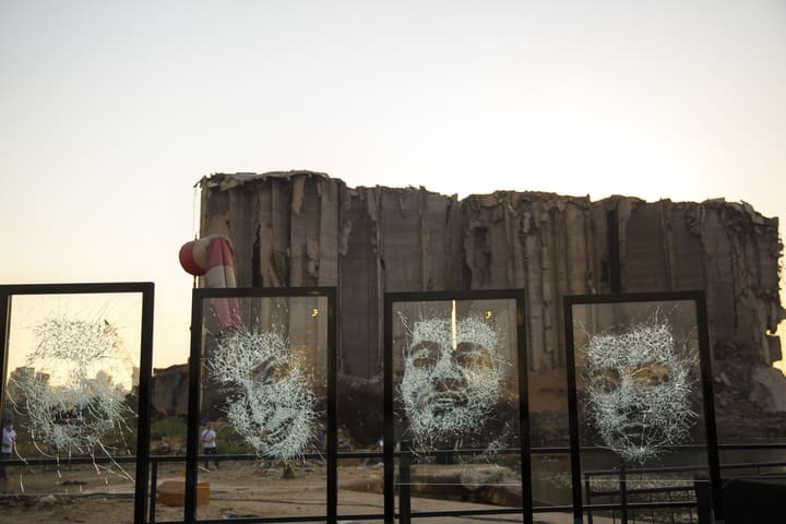 Portraits etched in glass stand at the explosion site in Beirut