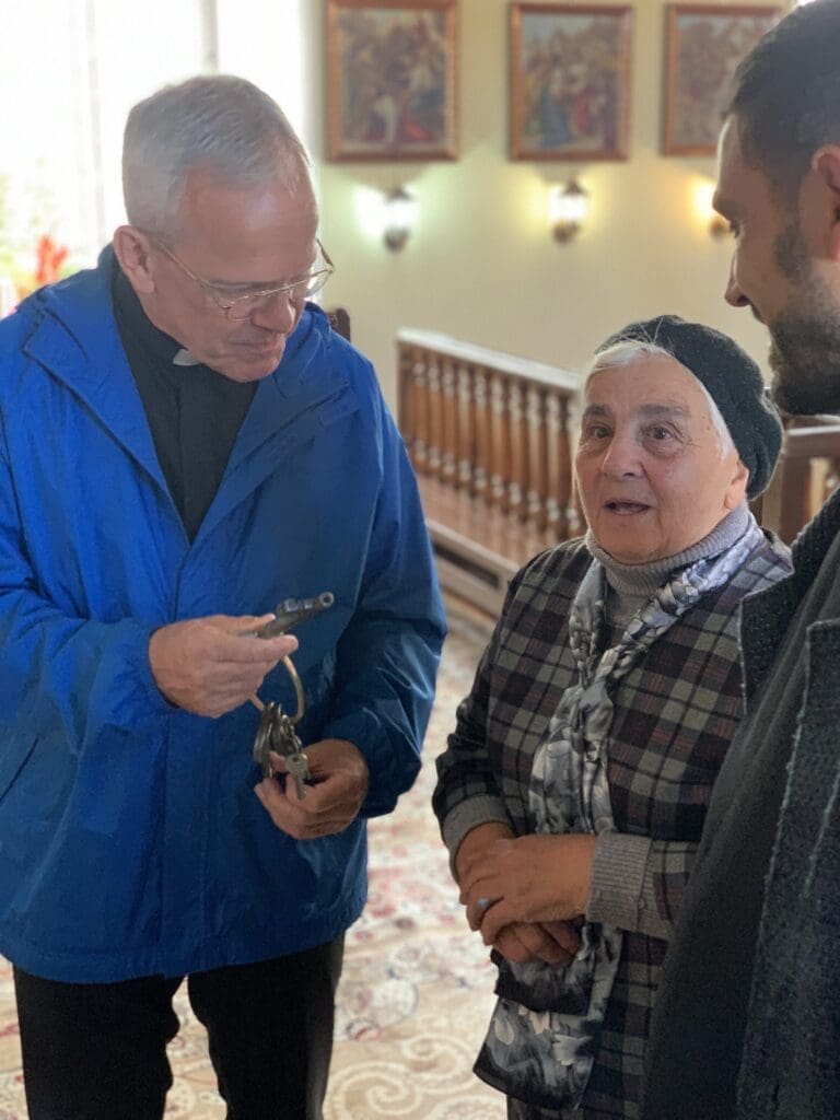 Msgr. Peter I. Vaccari visits with the sacristan of the Armenian Catholic Church in southern Georgia.