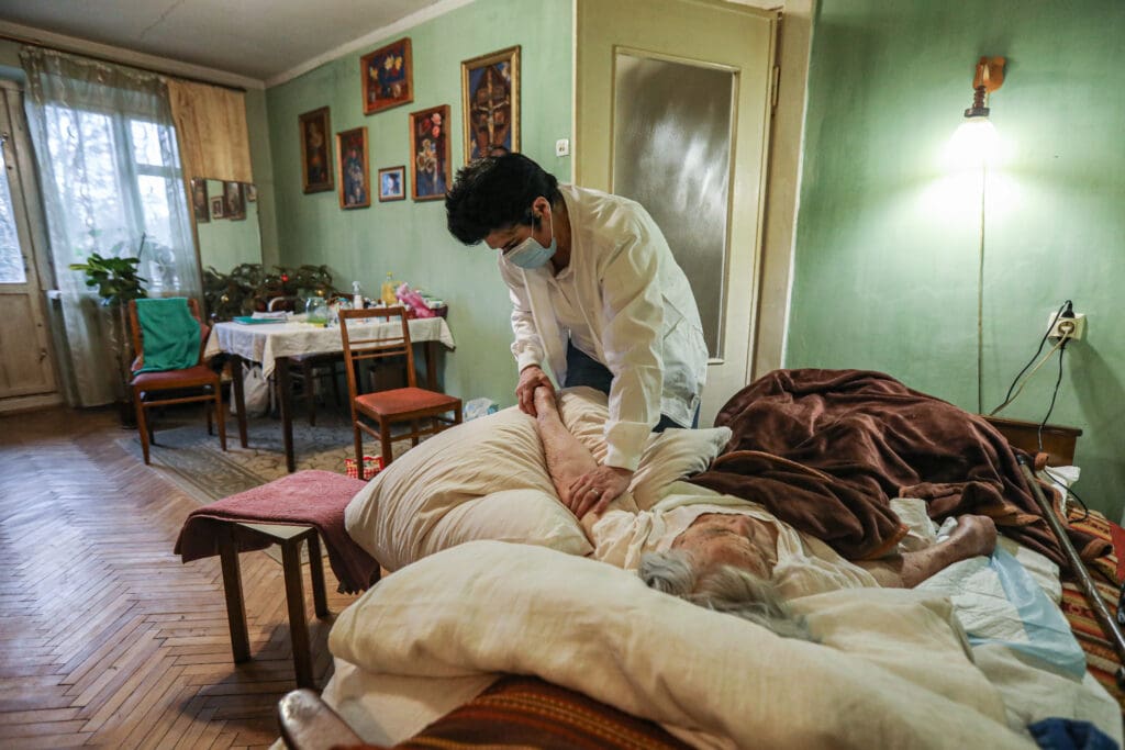 Liudmyla Shoshu, a nurse of the Sheptytsky Hospital in Lviv, provides palliative home care for an elderly patient on 23 January 2023