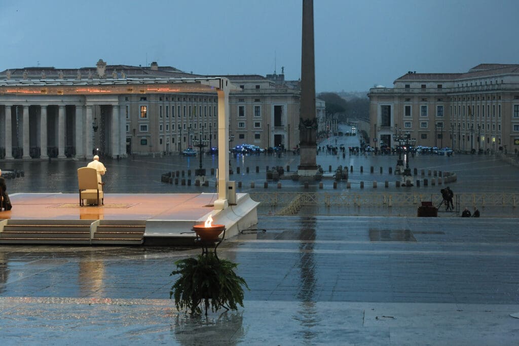 Pope Francis praying in an empty St. Peter’s Square.