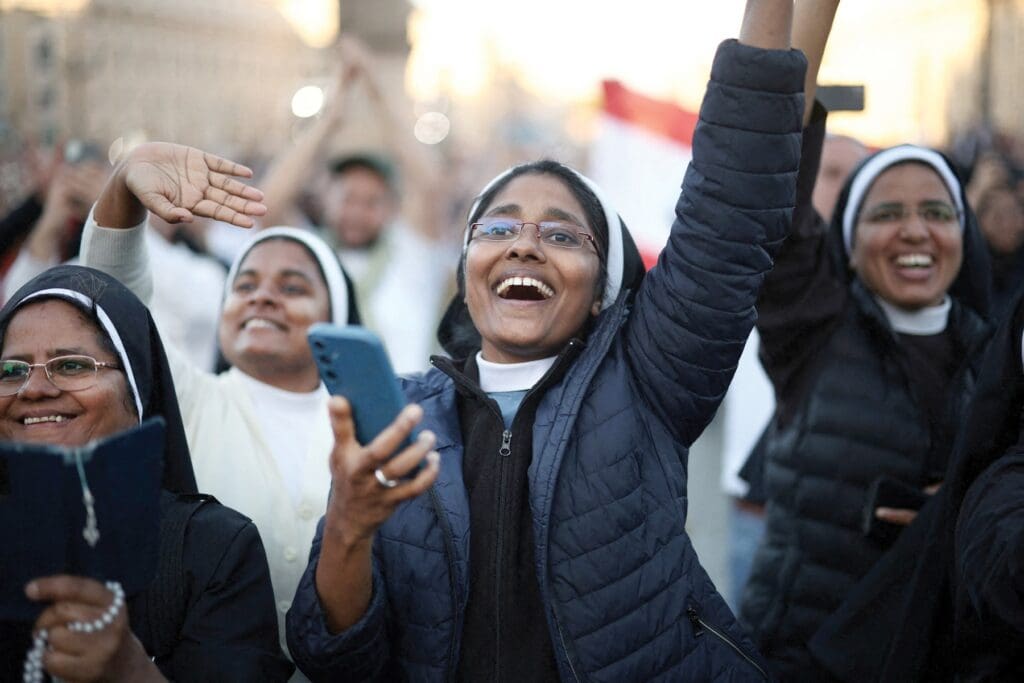 Religious women in St. Peter’s Square cheer.