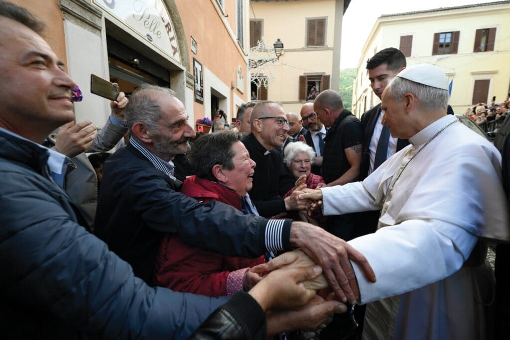 Pope Leo greets passersby in front of the 12th-century Augustinian Shrine of the Mother of Good Counsel in Genazzano, Rome.