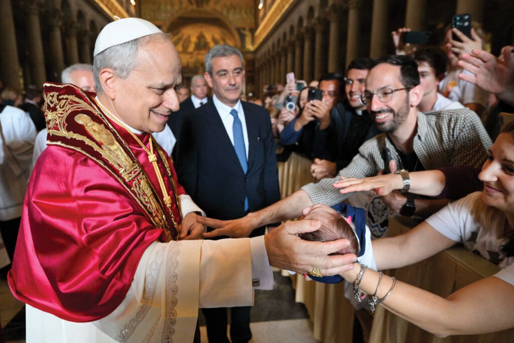 Pope Leo blesses a baby at the end of his first visit to the Basilica of St. Paul Outside the Walls in Rome.