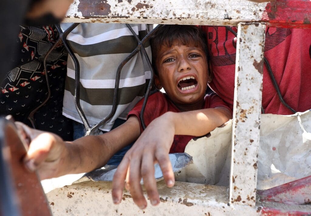 Dramatic close-up of child in Gaza crying for food.