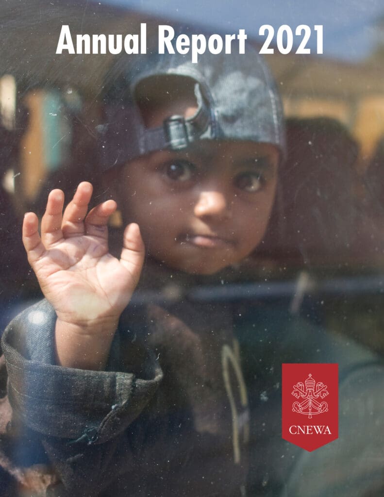 Cover image of this annual report features an infant wearing a backwards cap and raising a hand.