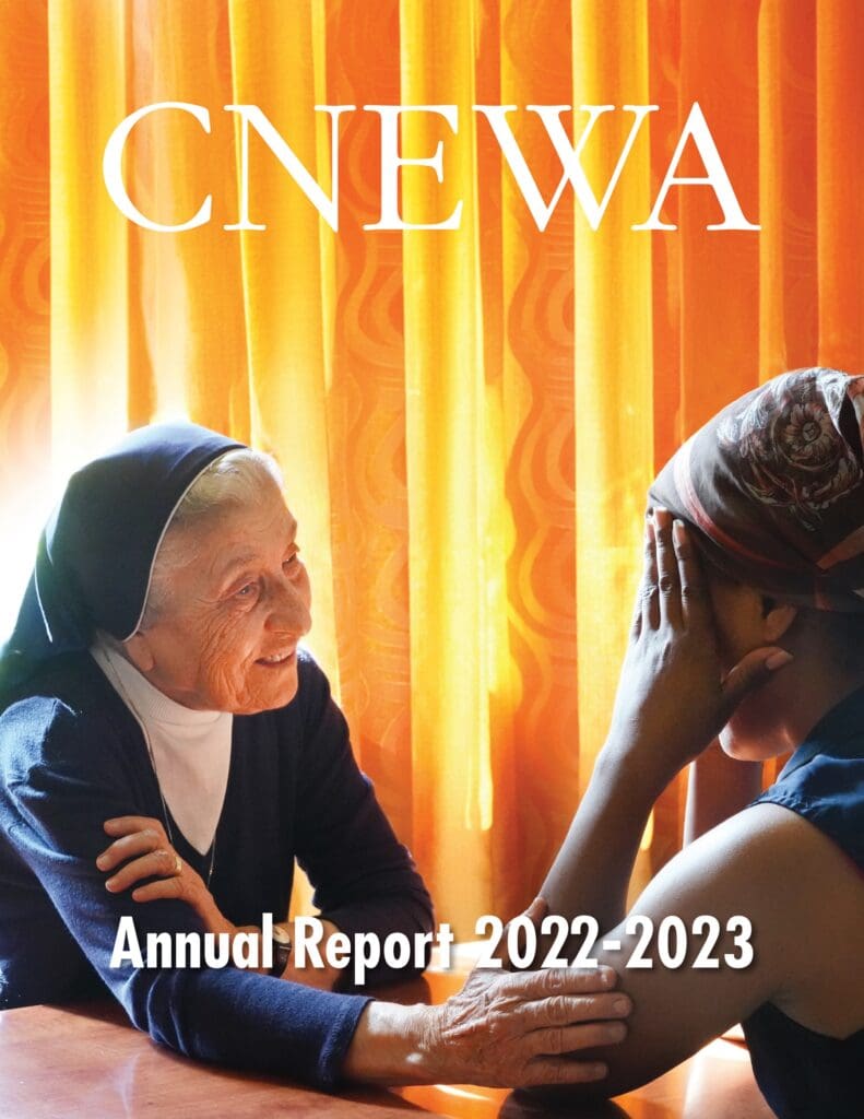 Cover image of the annual report features a religious sister talking to a woman.