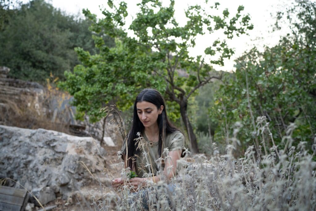 A woman picking herbs.