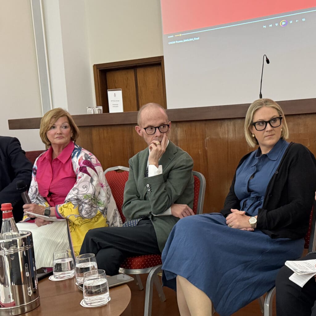Two women and a man sitting at a panel discussion.
