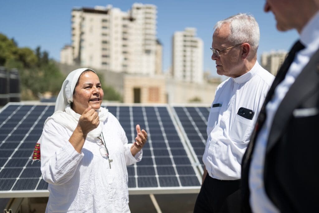 CNEWA-PMP President Msgr. Peter I. Vaccari talks to a Comboni Sister on a rooftop.