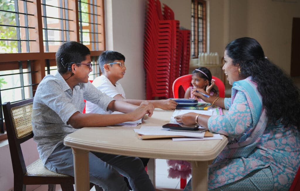 A teacher meets with children with special needs at Malankara Social Service Society.