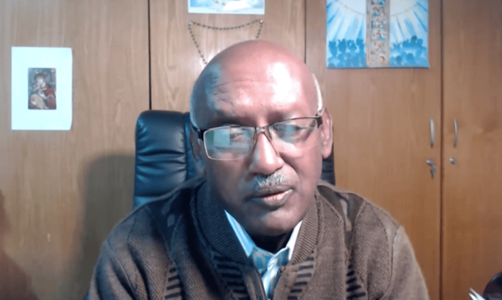 A mugshot of a man in an office.