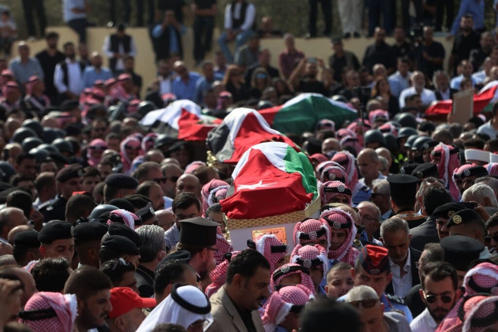 Masses of mourners attend a funeral.